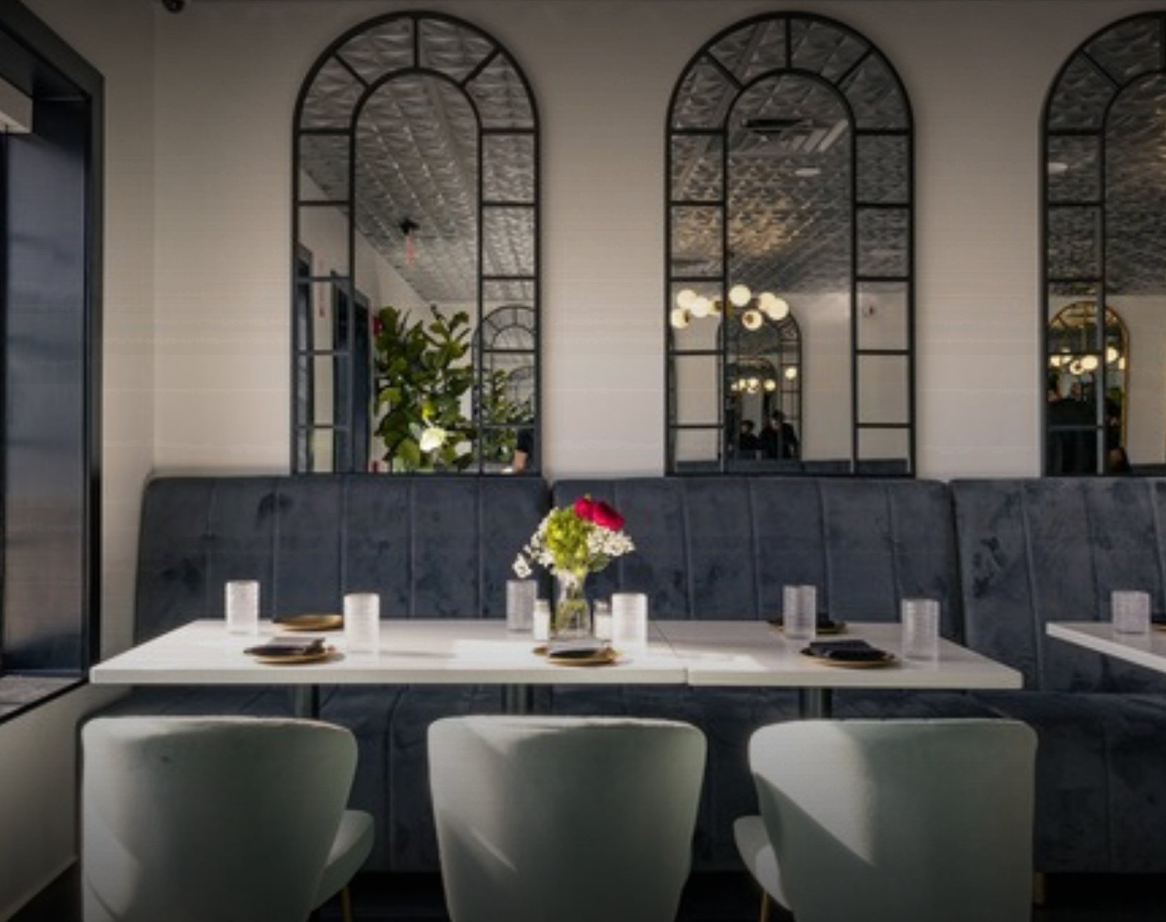 Grand Room tables under arched mirrors